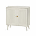 Meuble de rangement 2 portes 80 x 35 x 78 cm en MDF peint ivoire avec façades rainurées boutons dorés pieds en bois massif